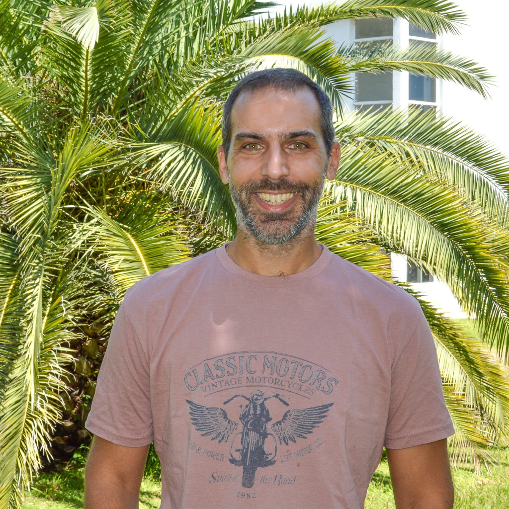 Dr. Emiliano Ravera. Foto de frente. Hombre sonriendo. Pelo corto y barba corta.